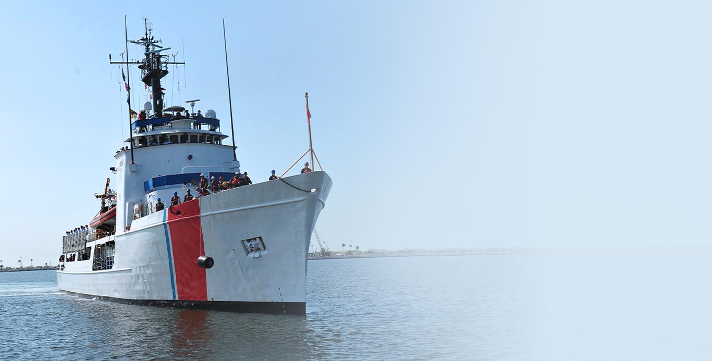 Large ship with maritime antennas and the crew standing on the bow