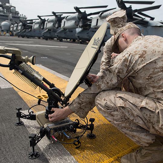 Two soldiers setting up a satellite terminal